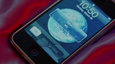 a close up of a cell phone on a red cloth