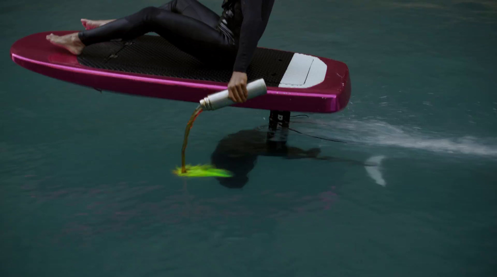 a person in a wet suit on a surfboard in the water