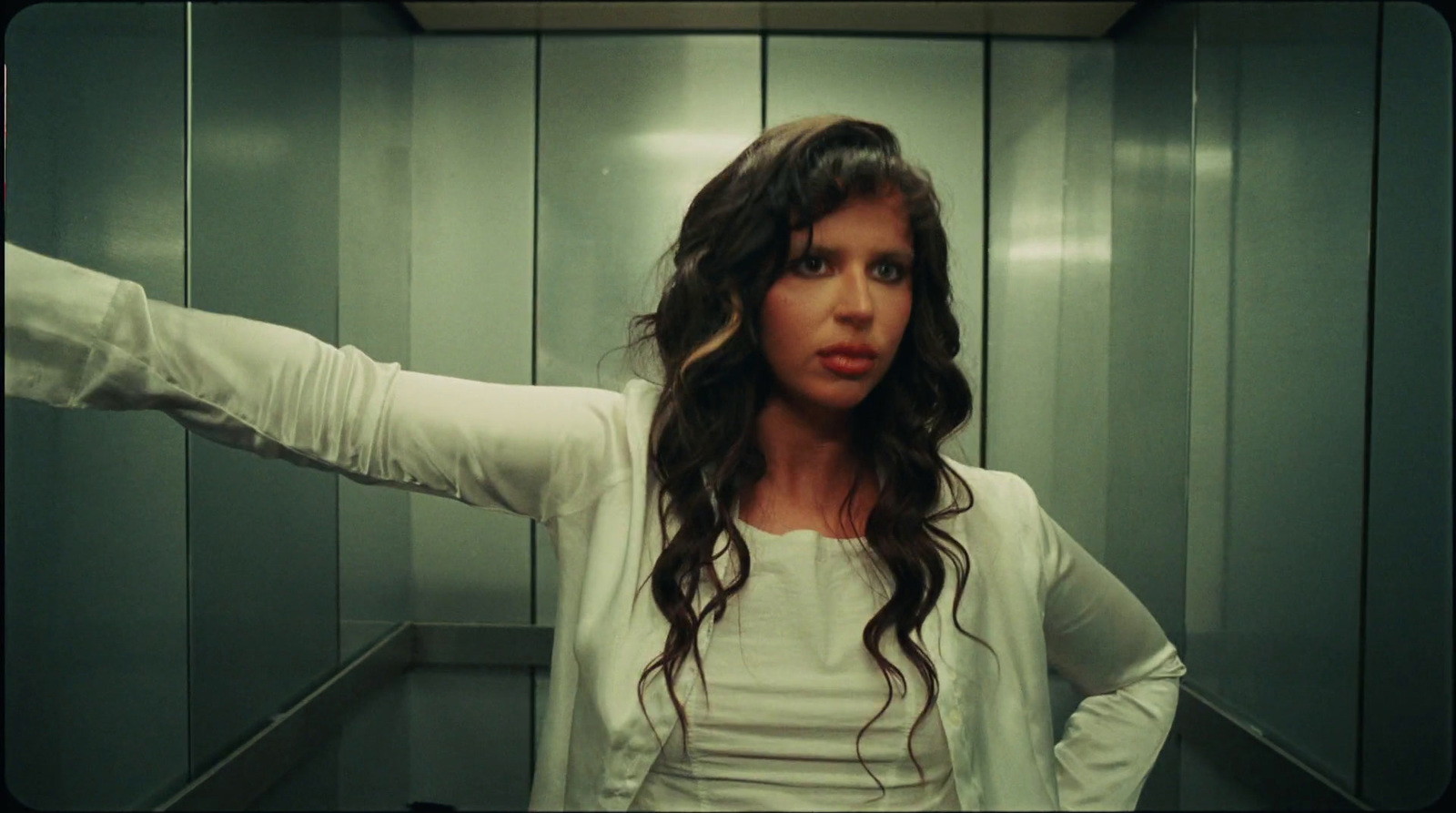 a woman standing in front of a mirror in a bathroom