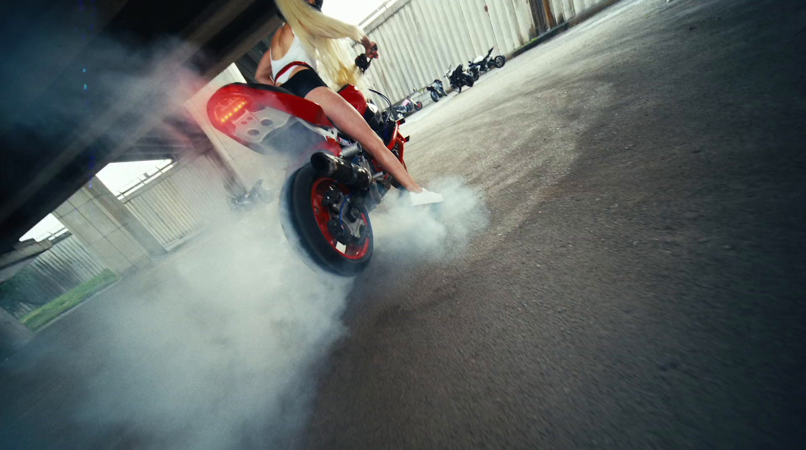 a woman riding on the back of a red motorcycle