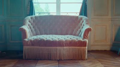 a chair sitting in a room next to a window