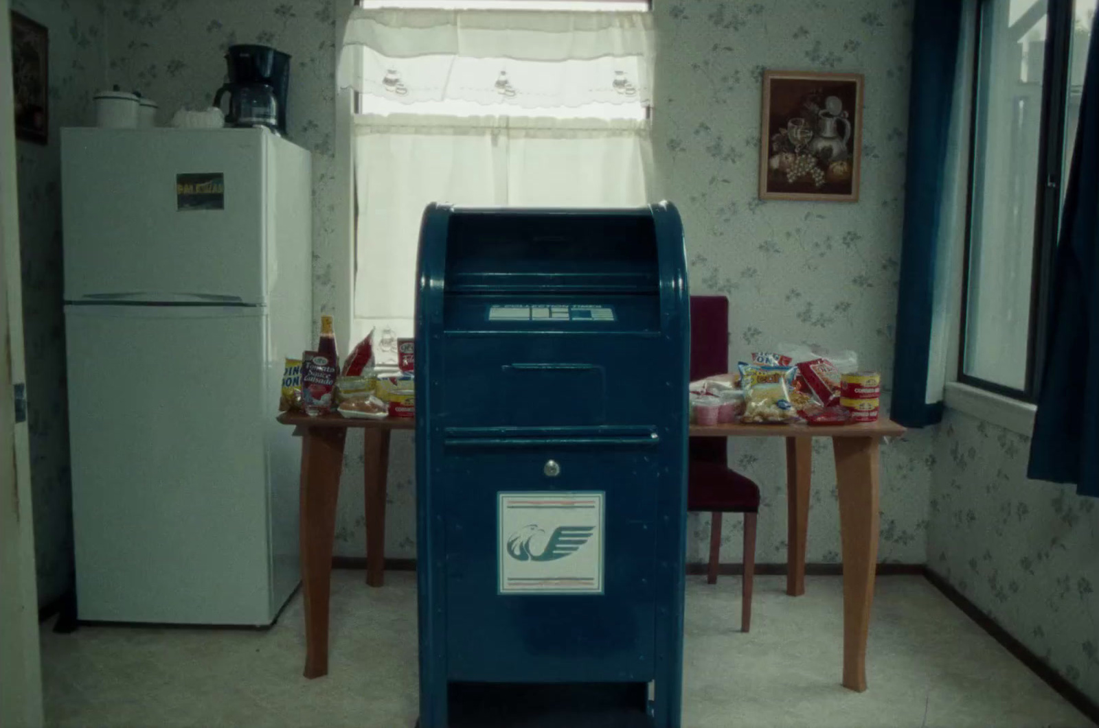 a blue mailbox sitting in the middle of a kitchen