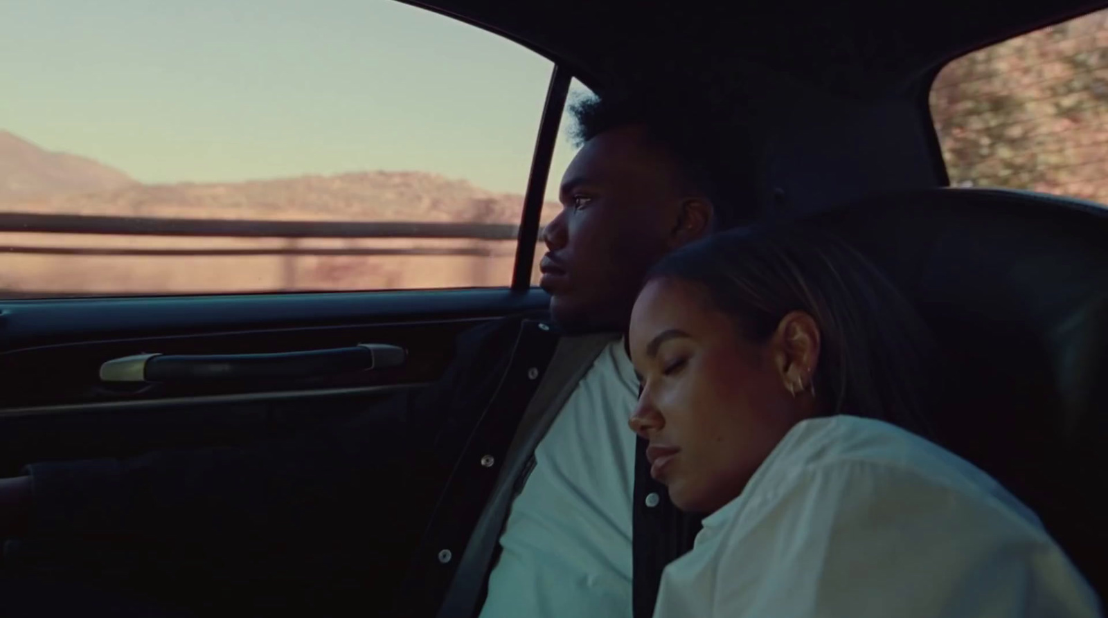 a man and a woman sitting in a car