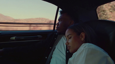 a man and a woman sitting in a car