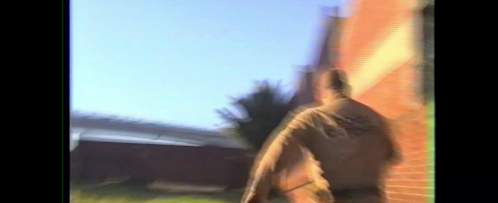 a blurry image of a man holding a tennis racquet