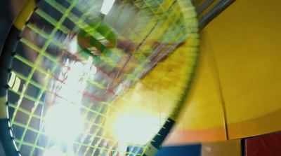 a close up of a tennis racket with a blurry background