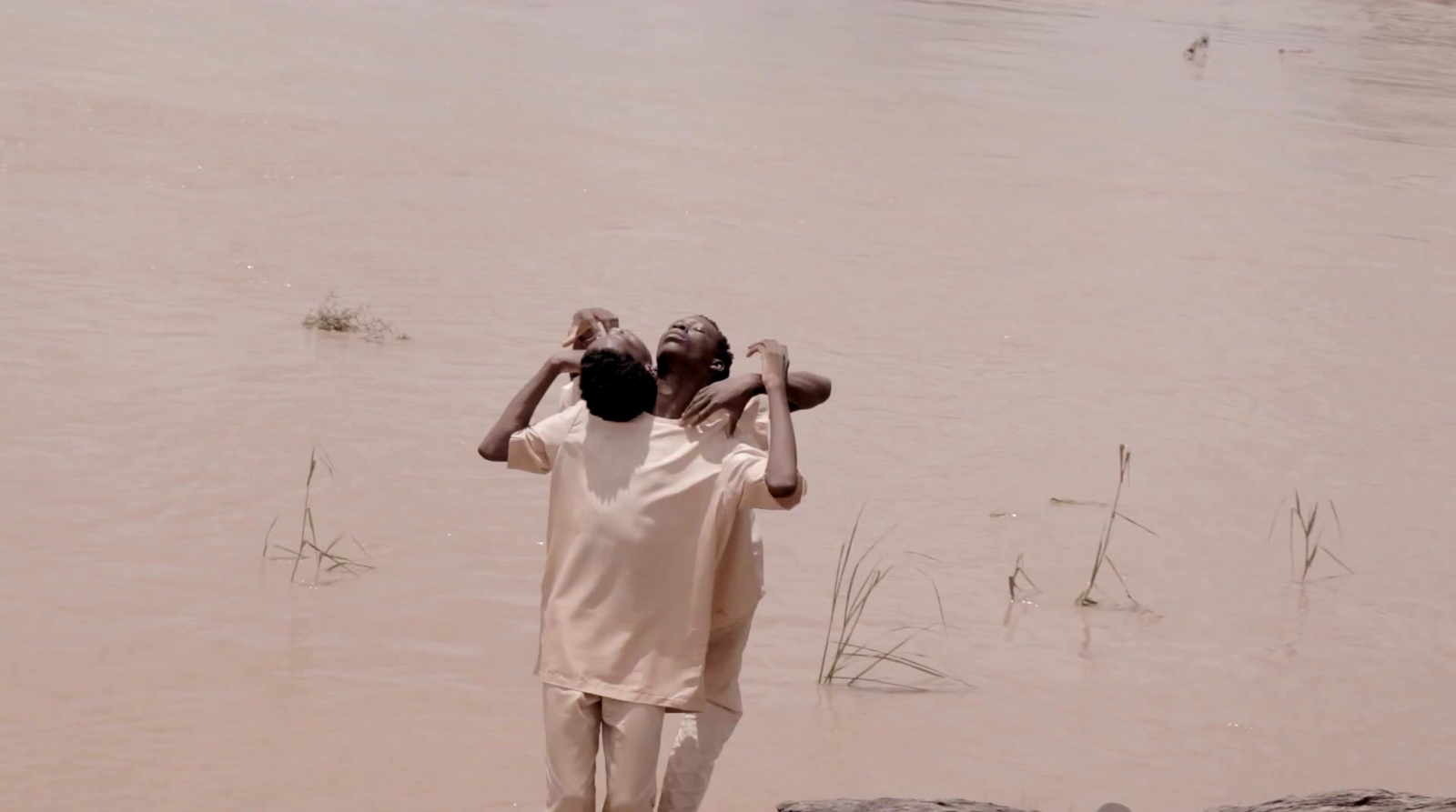 a couple of people standing in the water