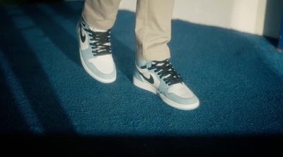 a person standing on top of a blue carpet