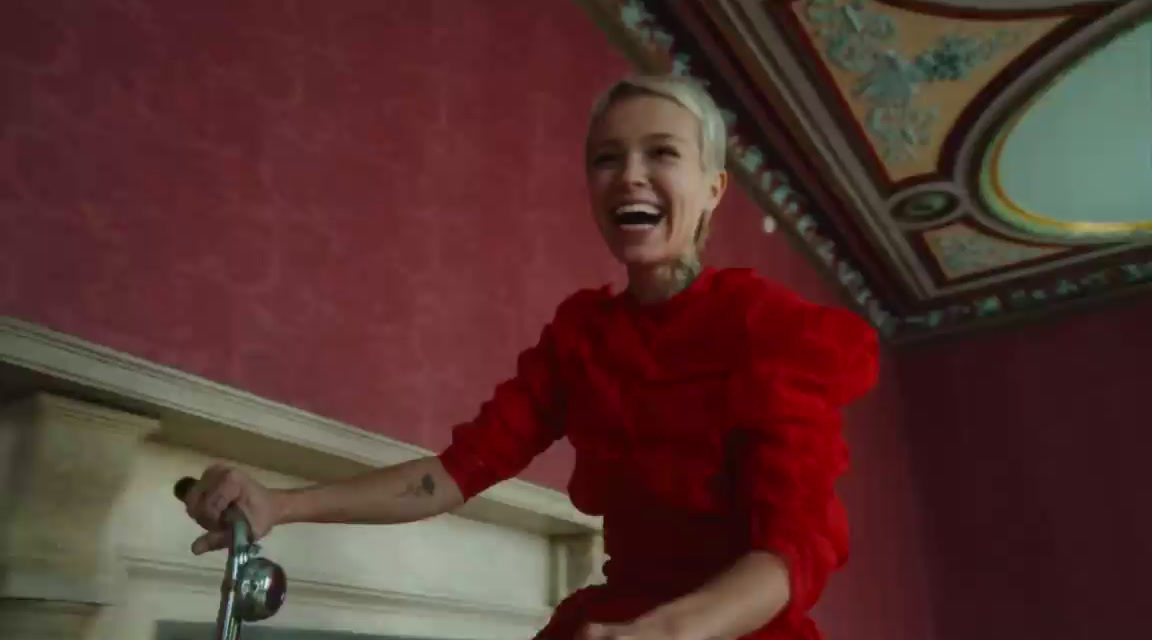 a woman in a red dress is laughing