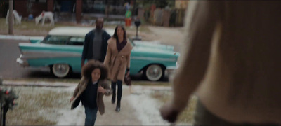 a group of people walking down a snow covered street