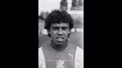 a black and white photo of a man with curly hair