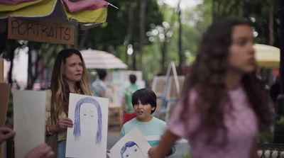 a group of people standing around holding signs