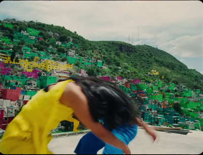 a woman in a yellow dress is skateboarding