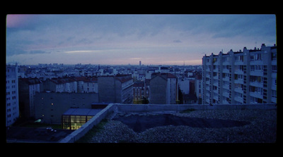 a view of a city at dusk from a rooftop