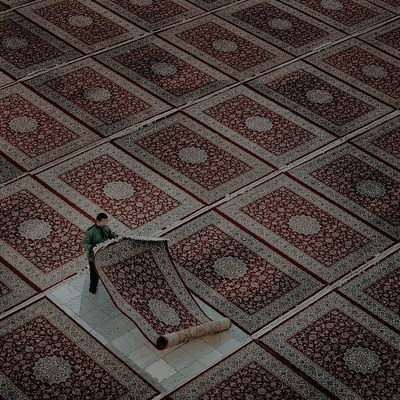 a man is standing on a large rug