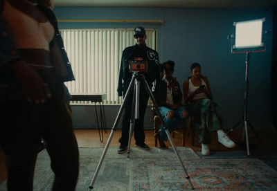 a man standing in front of a camera on a tripod