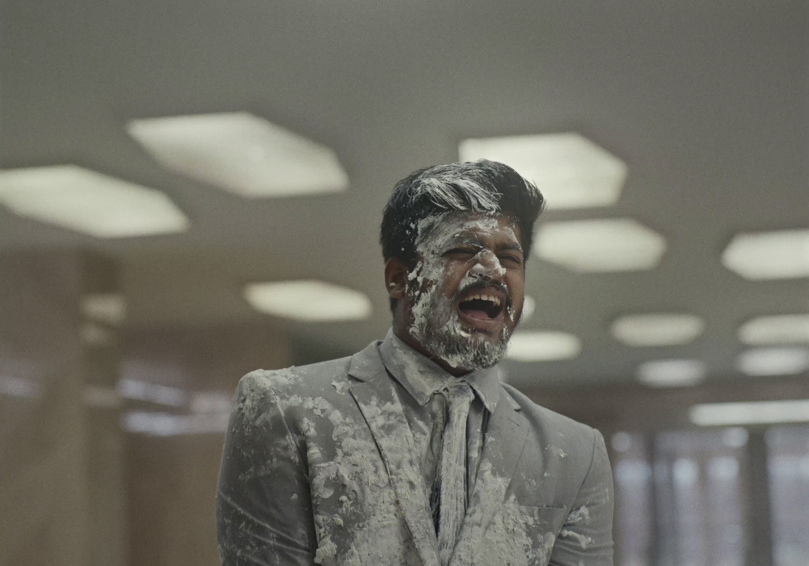 a man in a suit and tie covered in white powder