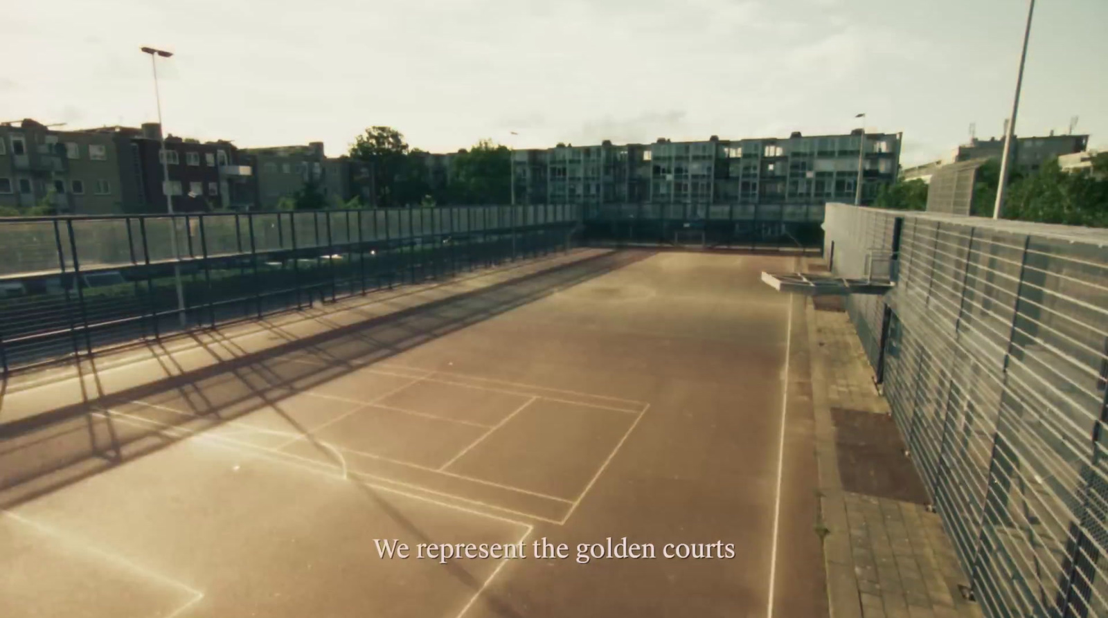 a tennis court with a fence surrounding it