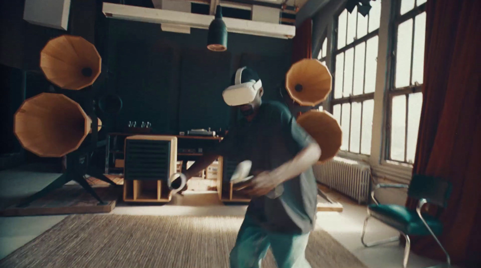 a man in a room with two large speakers on his head