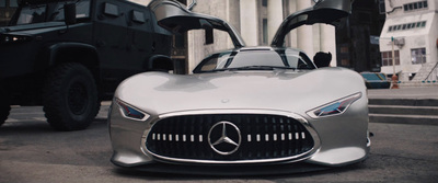 a silver mercedes sports car parked in front of a building