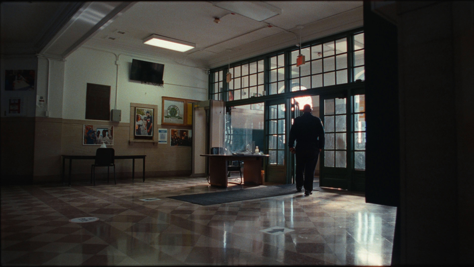 a man standing in a room with a door open