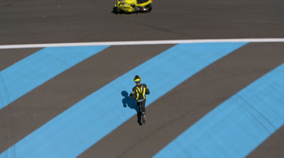 a person riding a motorcycle on a race track