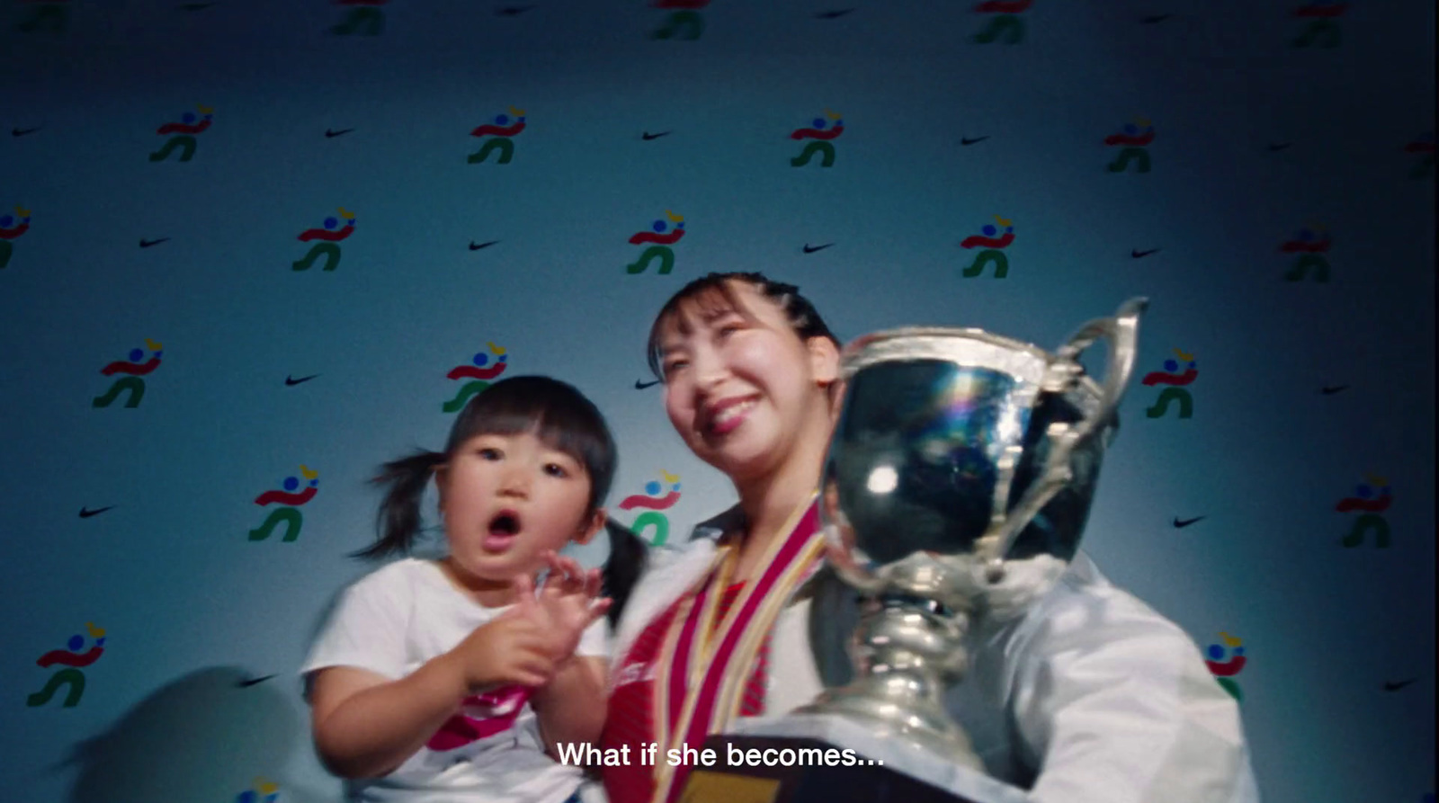 a woman and a child posing with a trophy