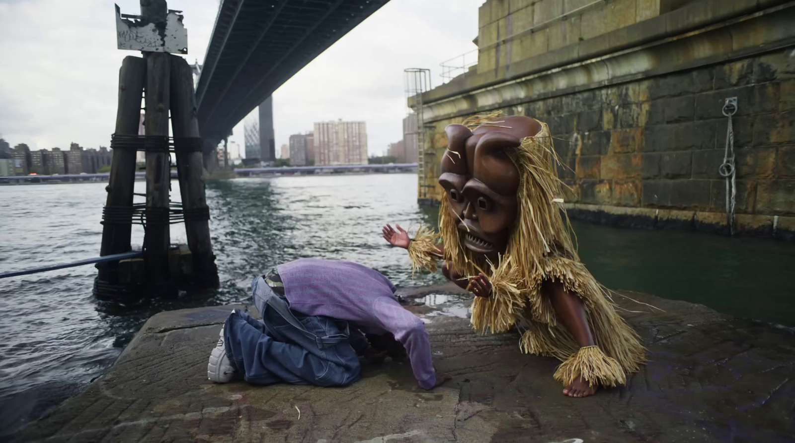 a statue of a lion sitting next to a body of water