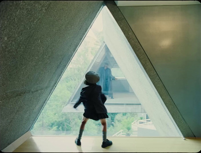 a young child standing in front of a window