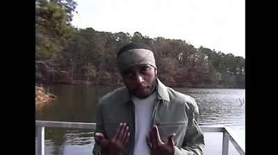 a man standing on a boat in front of a body of water