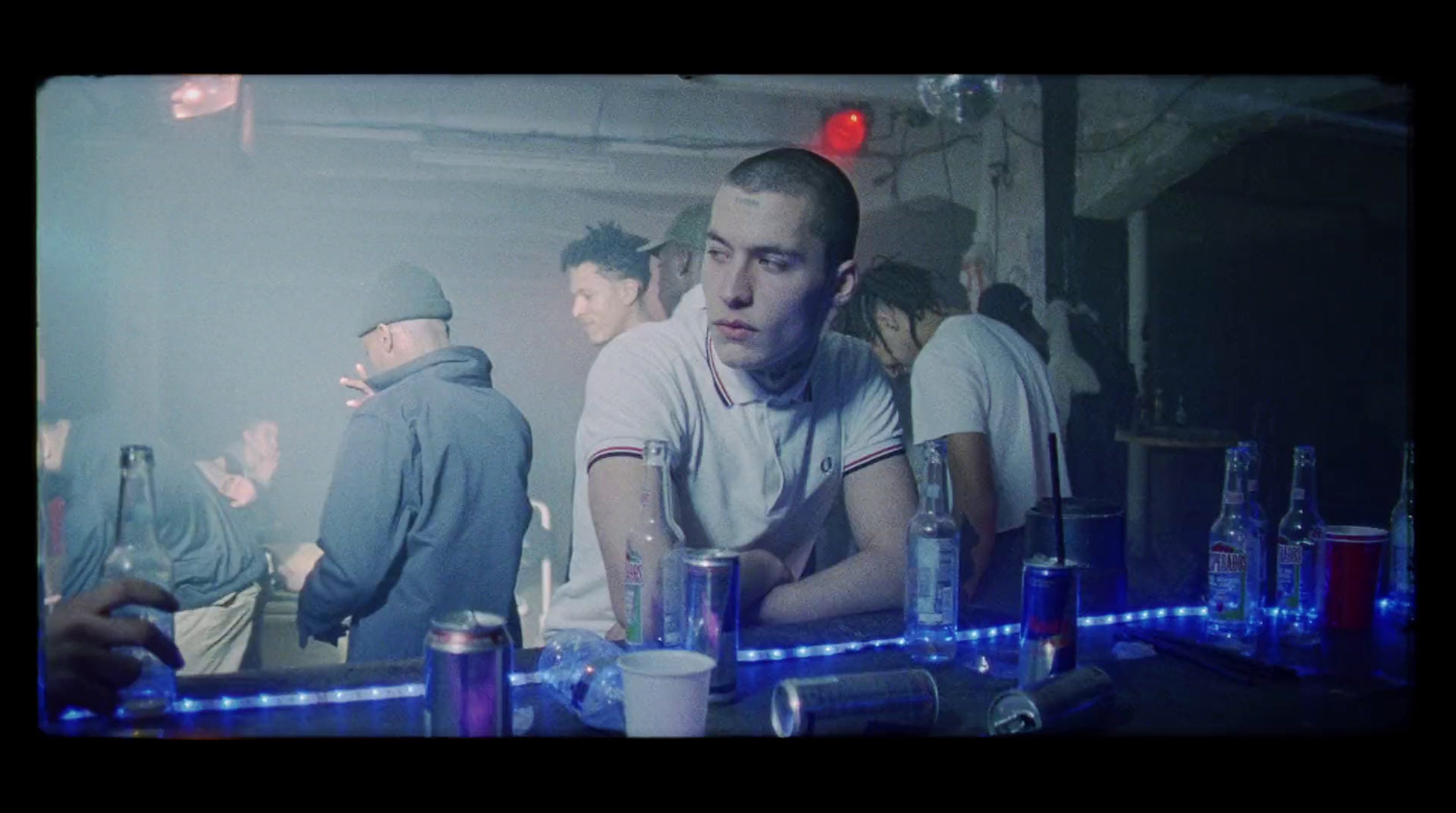 a group of people standing around a bar