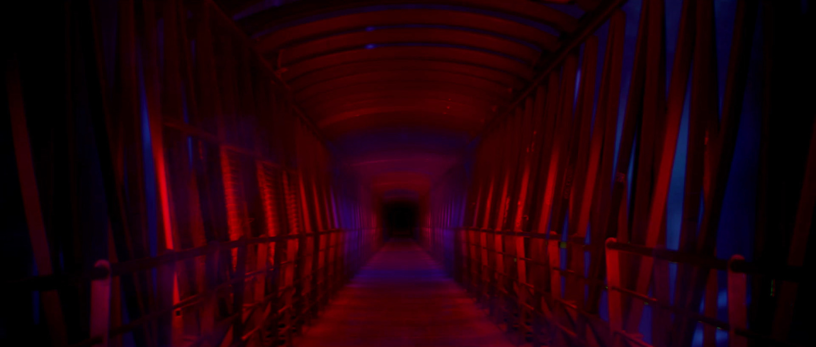 a long hallway with red and blue lights