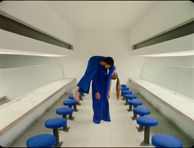 a man standing in a room with blue stools