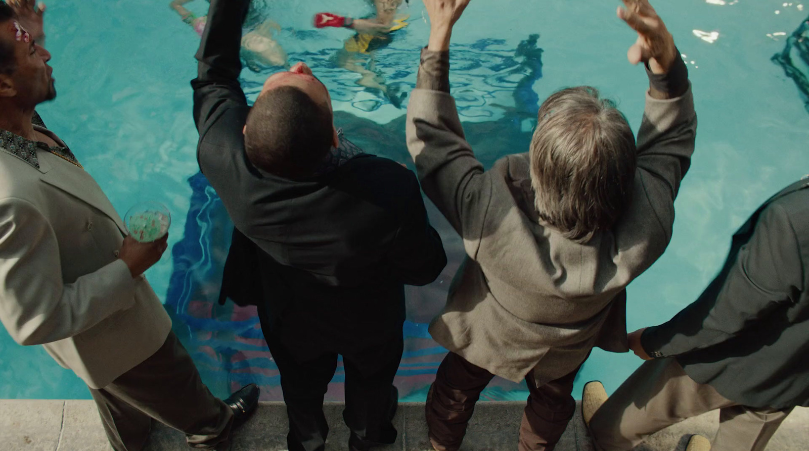 a group of people standing in front of a swimming pool