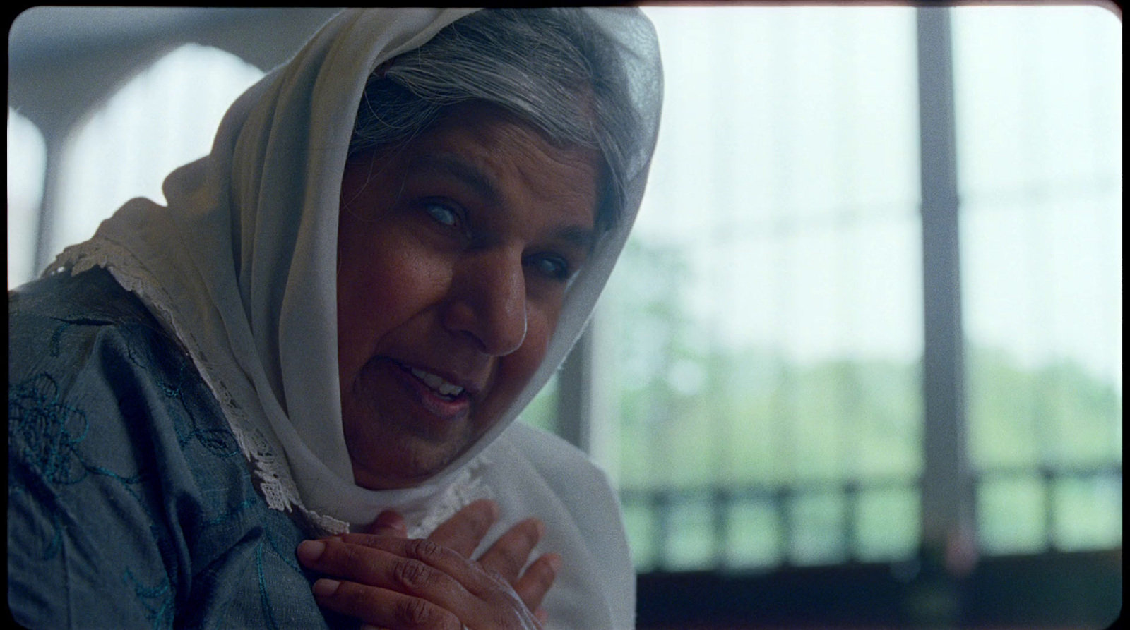 a woman with a white scarf around her head