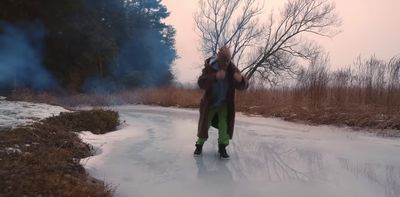 a man is standing on a frozen road