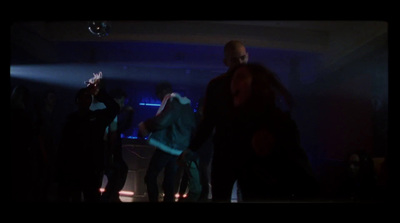 a group of people dancing in a dark room