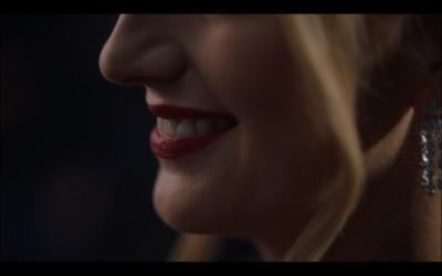 a close up of a woman's face smiling