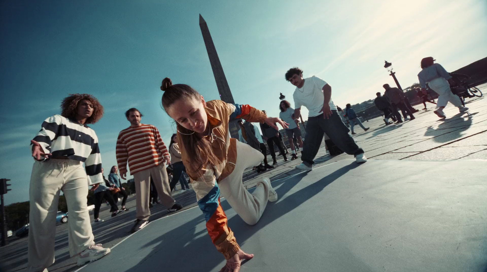 a young girl riding a skateboard down a ramp