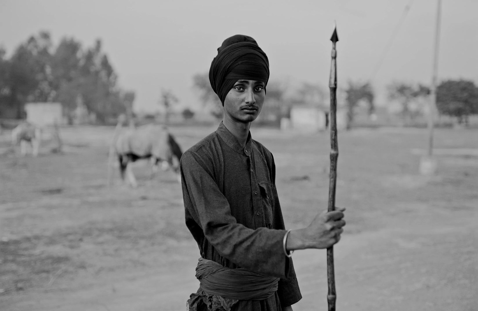 a man in a turban holding a stick