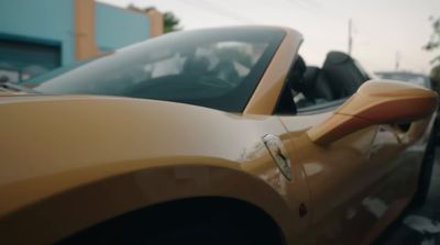 a yellow sports car parked in a parking lot