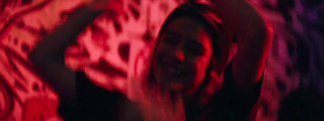 a blurry image of a woman dancing in a dark room