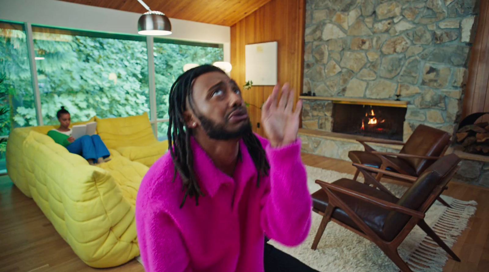 a man with dreadlocks sitting in a living room