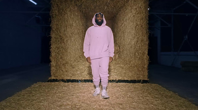 a person standing in front of a pile of hay