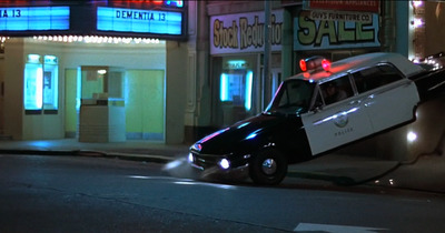 a police car is parked on the side of the road