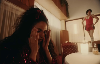 a woman sitting at a table with her hands on her face