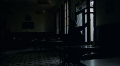 a person sitting at a table in a dark room