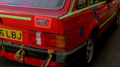 a red car parked on the side of the road