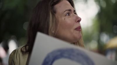 a close up of a person holding a sign