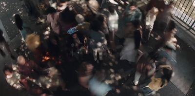 a crowd of people standing around each other